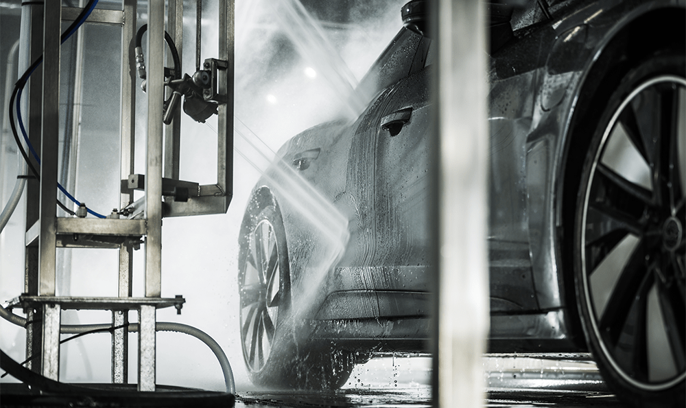 Dark colored car going through a car wash