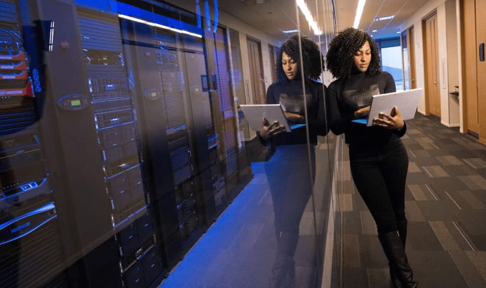 Professional woman standing in a server room